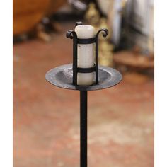 a candle holder is on top of a metal stand