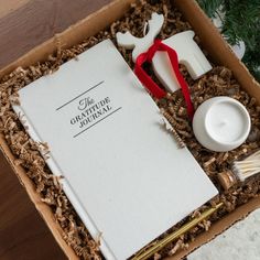 an open gift box filled with personal care items, such as toothbrushes and creams