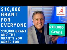 a man holding up a sign with the words $ 10, 000 grant for everyone