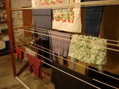 clothes are hanging on the clothesline in an old room