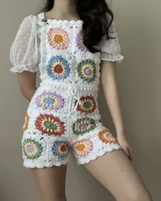 a young woman is posing for the camera in her crocheted outfit and sandals