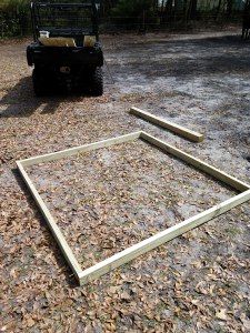 the frame is laying on the ground next to a forklift