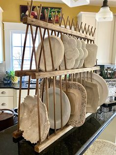 a rack filled with plates on top of a kitchen counter