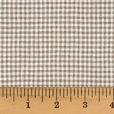 a ruler with a white and brown checkered fabric