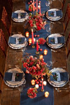 the table is set with candles, plates and napkins for an elegant dinner party