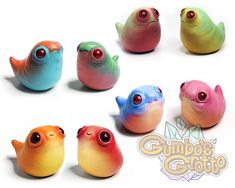 six different colored birds sitting next to each other on a white surface with the words gumbo's goto written above them