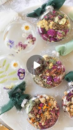 four glass bowls filled with different types of flowers