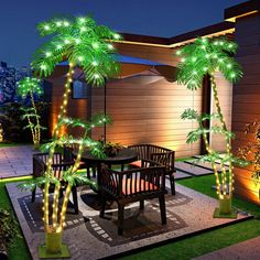 an outdoor dining area with palm trees and lights