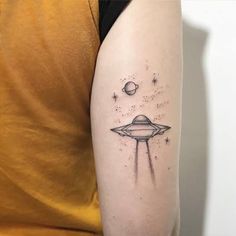 a woman's arm with a tattoo on it that has an image of saturn and stars