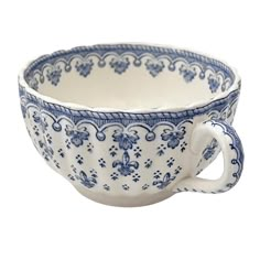 a blue and white bowl with an ornate design on the rim, in front of a white background