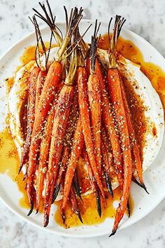 carrots on a plate with mustard and seasoning