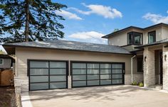 a large house with two garages in front of it