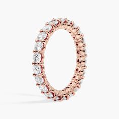 a rose gold ring with white and red stones on the inside, set in 18k pink gold