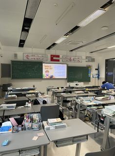 an empty classroom with desks and chalkboards