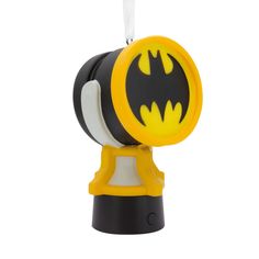 a batman light up ornament hanging from a string on a white background in the shape of a flashlight