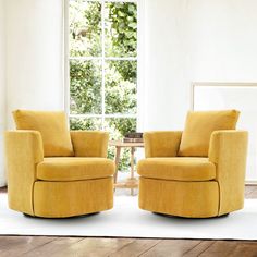 two yellow chairs sitting next to each other on top of a white rug in front of a window