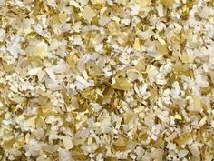 gold and white glitter flakes are scattered on the floor in this image, as if it were made out of paper machs