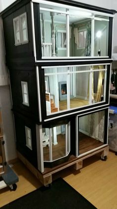 a doll house with multiple floors and windows