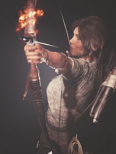 a woman holding a bow and arrow with fire in her hand while standing on a black background