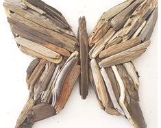 a butterfly made out of driftwood on a white background