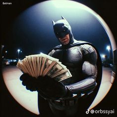 a man in a batman costume holding money