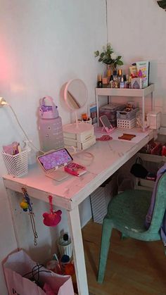 a white desk topped with lots of clutter next to a chair and table lamp