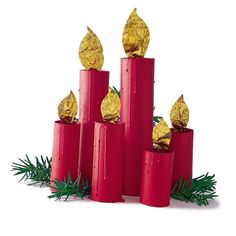 four red candles with gold foil wrapped in evergreen leaves and pine cones on each pillar