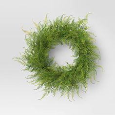 a green wreath is hanging on the wall