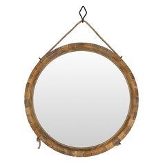 a round wooden mirror hanging on a rope