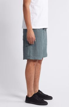 Weekend styling is a breeze in these relaxation-ready linen shorts that have plenty of pockets for on-the-go storage. 9" inseam; 25 1/2" leg opening; 12 1/4" front rise Elastic/drawstring waist Side-seam pockets; cargo flap-patch pocket 100% linen Hand wash, line dry Imported Casual Bermuda Shorts With Side Pockets And Relaxed Fit, Relaxed Short Bottoms With Pockets, Casual Linen Bermuda Shorts With Relaxed Fit, Casual Linen Bottoms With Side Pockets, Relaxed Short Bottoms With Side Pockets, Casual Linen Shorts With Side Pockets, Relaxed Short Length Bottoms With Side Pockets, Vacation Linen Bottoms With Side Pockets, Casual Linen Bermuda Shorts For Beach