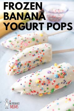 frozen banana yogurt pops with sprinkles on them and bananas in the background