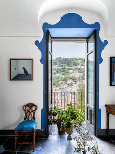 an open door leading to a balcony with potted plants