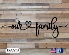 the word our family is written on wood planks with an american flag in the background