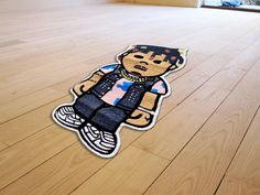 a wooden floor with a sticker of a boy on it