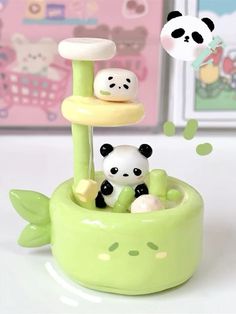 two panda bears are sitting in a green plant