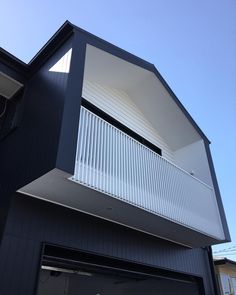 a black house with white balconies on the balcony