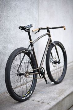 a black and silver bike parked on the side of a building