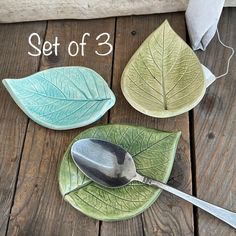 three leaf shaped plates with spoons on them and the words set of 3 written below