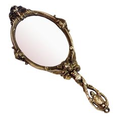 an ornate gold mirror is shown against a white background