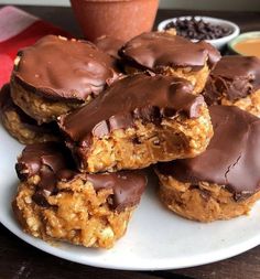 chocolate covered cookies on a white plate with dipping sauce