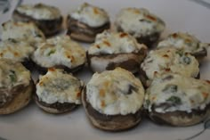 a plate full of stuffed mushrooms with cheese