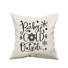 a white pillow with the words baby it's cold outside on it and snowflakes