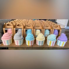 cupcakes with different colored frosting are on display