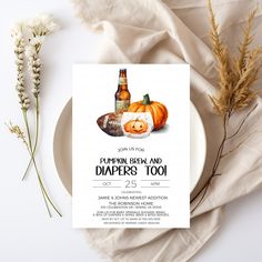 a pumpkin beer and diaper's too baby shower is displayed on a plate