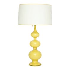 a yellow table lamp with a white shade on the top and bottom, against a white background