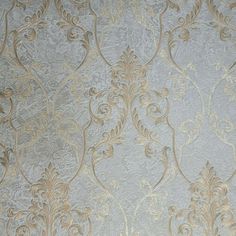 the wall paper has gold and silver designs on it