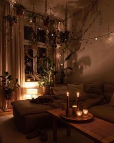 a living room filled with furniture and candles