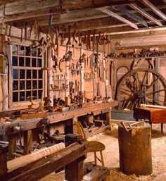 an old workshop with many tools hanging on the wall