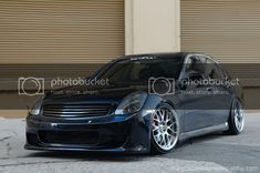 a black car parked in front of a building