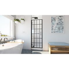 a white bath tub sitting under a window next to a painting on the side of a wall